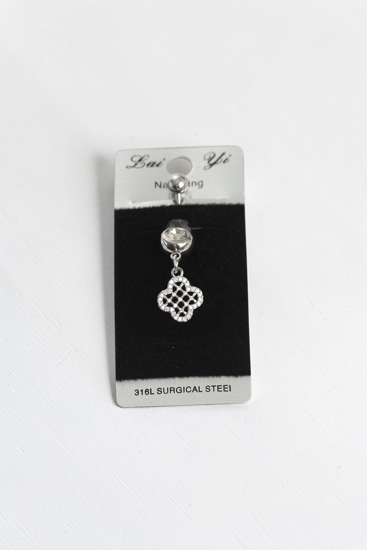 VORA HOUSE 316L surgical steel belly button piercing with a dangling clover charm and sparkling zircon stones.