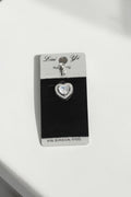 VORA HOUSE heart-shaped belly piercing made of 316L surgical steel with sparkling zircon stones on a display card.