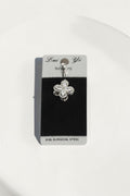 VORA HOUSE surgical steel belly button piercing with a rotating clover design featuring sparkling zircon stones.