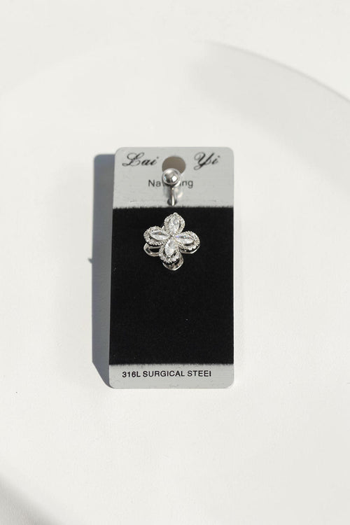 VORA HOUSE surgical steel belly button piercing with a rotating clover design featuring sparkling zircon stones.