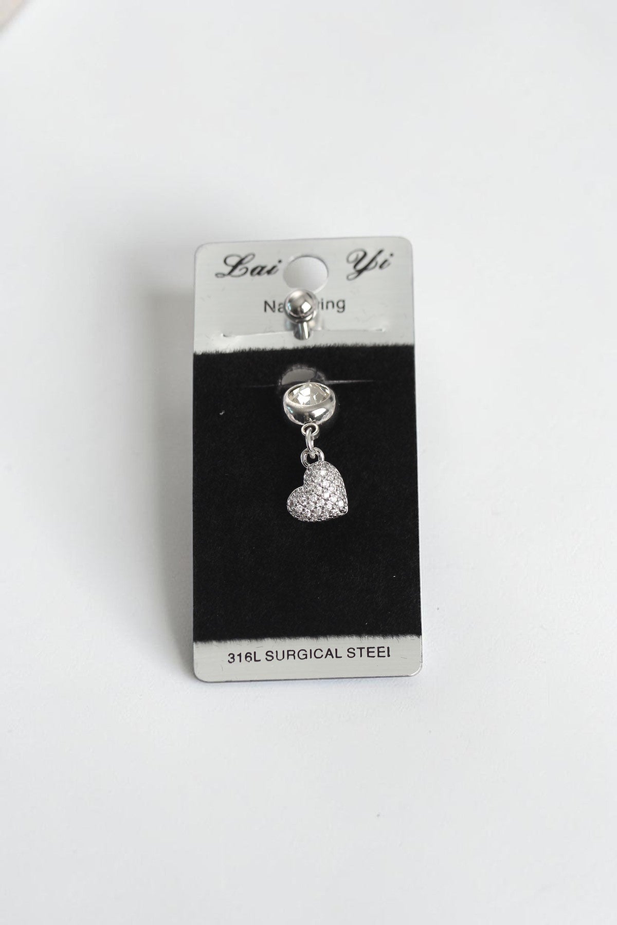 VORA HOUSE 316L surgical steel belly button piercing featuring a dangling heart charm with sparkling zircon stones.