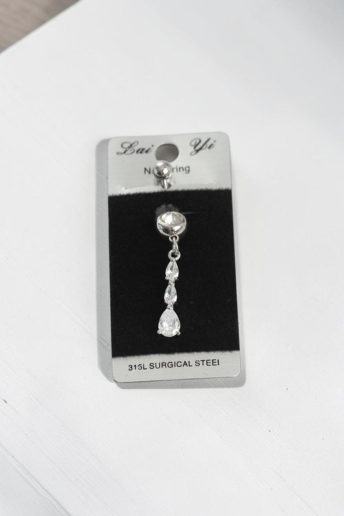 VORA HOUSE 316L surgical steel belly button ring featuring three dangling teardrop-shaped zircon stones on a card.